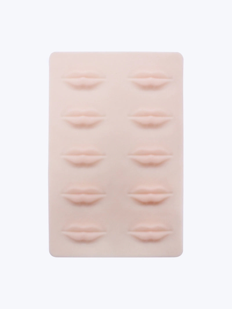 Silicone practice skin with raised eye and lip forms